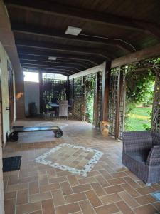 a screened in porch with a couch and a table at Aquada Experience in Francavilla al Mare +6 photos