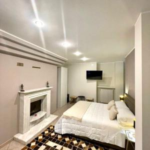 a bedroom with a bed and a fireplace at Aquada Experience in Francavilla al Mare