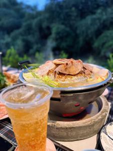 a plate of food in a pan on a table at มนต์จันทรา เฮ้าส์ in Khlong Lan