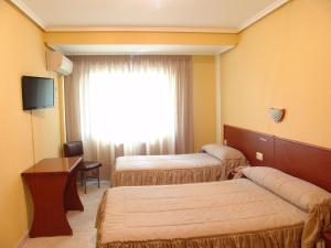Postel nebo postele na pokoji v ubytování Hostal Athlanta