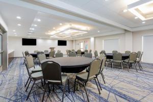 a conference room with a large table and chairs at Holiday Inn Express & Suites Tampa Stadium - Airport Area by IHG in Tampa +62 photos