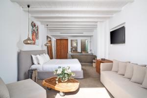 a living room with two beds and a couch at Hippie Chic Hotel in Agios Ioannis Mykonos