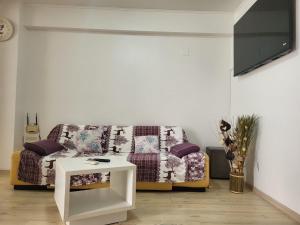 a living room with a couch and a table at Black Sea in Constanţa