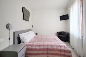 a bedroom with a bed with a checkered blanket at Santa Caterina - Nel Cuore di Crema in Crema