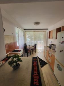 a kitchen and dining room with a table and a kitchen with a dining room at Black Sea in Constanţa