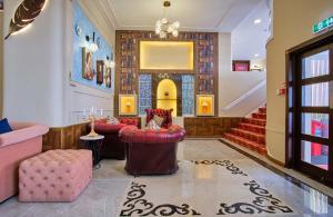 a lobby with red chairs and a staircase at Muthu Oban Regent Hotel- Refurbished in Oban