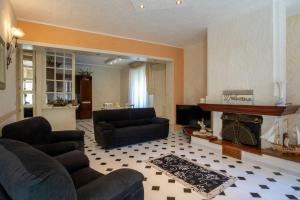 a living room with two couches and a fireplace at Mare In Vista in Capoliveri +18 photos