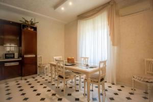 a dining room with a white table and chairs at Mare In Vista in Capoliveri