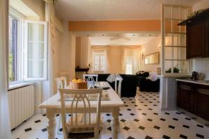 a kitchen and living room with a table and chairs at Mare In Vista in Capoliveri