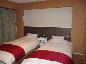 Postel nebo postele na pokoji v ubytování Town Hotel 41