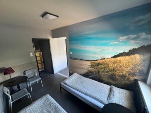 a room with a large painting of a beach at KEJA Pustkowo in Pustkowo