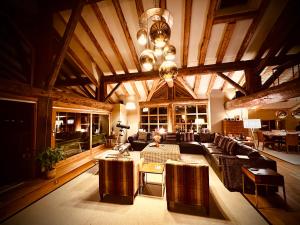 a large living room with a couch and a table at Chalet Violettes in Villaroger
