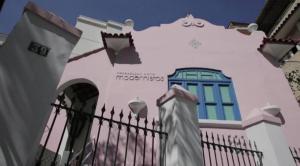 a white building with a fence and a window at Modernistas Arte in Rio de Janeiro