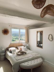 a bedroom with a bed with a large window at Villa Boho Cassis in Cassis