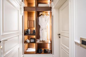 a closet with a white robe on a shelf at LaFe Boutique Hotel in Sarandë