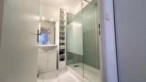 ein Badezimmer mit Dusche und Glastür in der Unterkunft L'échappée in Fort-Mahon-Plage