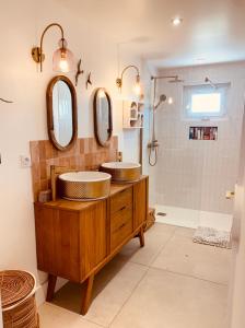 a bathroom with two sinks and two mirrors at Villa Boho Cassis in Cassis +9 photos