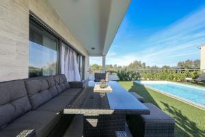 a living room with a couch and a pool at Orchid Stay in Ždrelac