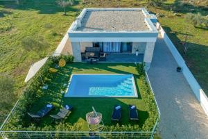 an overhead view of a house with a swimming pool at Orchid Stay in Ždrelac +30 photos