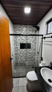 a bathroom with a shower and a toilet and a sink at Pousada Canto do Cedro in Lençóis +16 photos