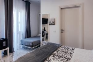 a bedroom with a bed and a mirror at Capitani Guest House in Fiumicino