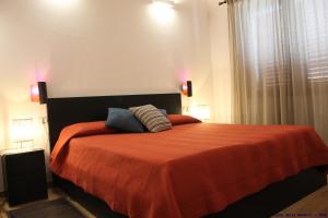 a bedroom with a bed with two pillows on it at Casa delle rondini in SantʼAnna Arresi