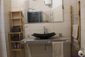 a bathroom with a sink and a mirror at Casa delle rondini in SantʼAnna Arresi +37 photos