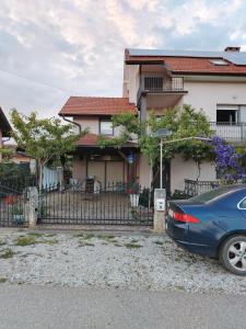 a blue car parked in front of a house at Apartman BS in Velika Gorica
