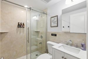 a bathroom with a shower and a toilet and a sink at Stay at Luna at Convention Center in Philadelphia