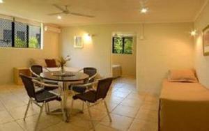 a living room with a dining table and chairs at Horizons Motel in Gold Coast