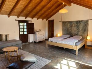 a bedroom with two beds and a table at Moinhos do Paneiro in Santiago do Cacém