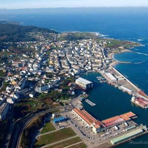 an aerial view of a harbor next to the ocean at Alesamar A in Burela de Cabo