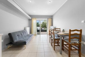 a living room with a couch and a table at Abatis CityHome in Lefkada