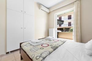 a bedroom with a bed and a window at Abatis CityHome in Lefkada