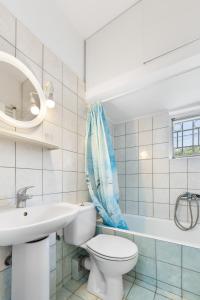 a bathroom with a toilet and a sink and a tub at Abatis CityHome in Lefkada +22 photos