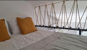a bed in a room with a view of the ocean at Aloft Apartment in Budva