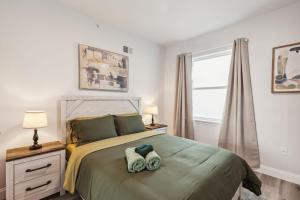 a bedroom with a bed with two towels on it at Stay at Luna at Convention Center in Philadelphia