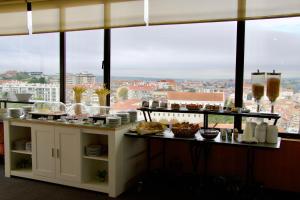 a breakfast buffet with a view of a city at Hotel Eurosol Leiria & Jardim in Leiria