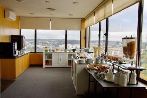 a kitchen with a bunch of food on a counter at Hotel Eurosol Leiria & Jardim in Leiria
