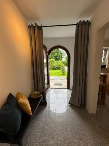 a living room with a couch and an open door at Wohnung mit Garten am See in Langenargen