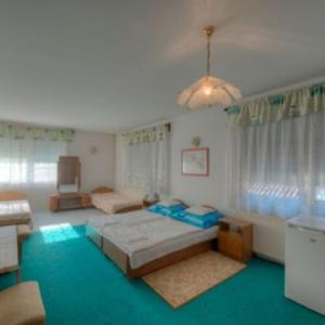 a large room with a bed and a couch at Retro Nádas Vendégház in Balatonlelle +14 photos