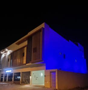 a building with blue lights on it at night at فندق اللحظات السعيدة in Riyadh