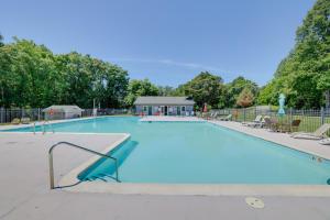 a large swimming pool with blue water at Smith Mountain Lake Home with Private Hot Tub and Dock in Moneta
