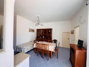 a room with a table and a bed and a desk at Casa Francesca - Immobilevante in Ponza +11 photos