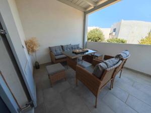 a balcony with a table and chairs and a couch at Mantalena's house in Antiparos