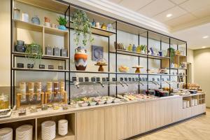 a display case in a store with dishes and vases at Courtyard by Marriott Magdeburg in Barleben