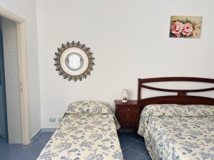 a bedroom with two beds and a mirror on the wall at Casa Francesca - Immobilevante in Ponza
