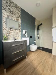 a bathroom with a sink and a toilet in it at A de Carmiña in A Coruña +15 photos