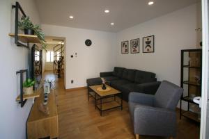 a living room with a couch and a table at Family House Bubalo in Opuzen