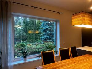 a window in a dining room with a table and chairs at Pirita Beach Villa in Tallinn